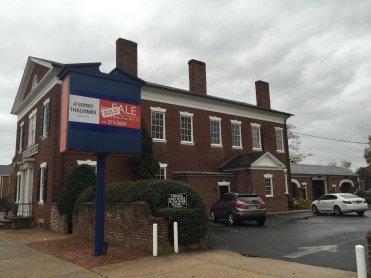 The west wall of the Farmers' Bank with the drive through on the right. Note the sale sign. 